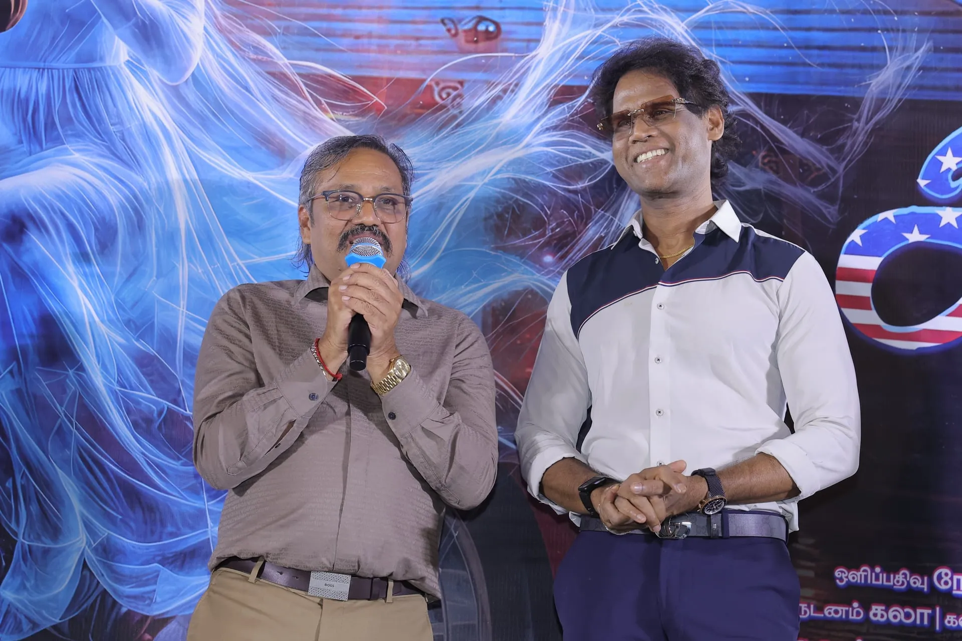 A guest speaks at the America Aavi audio and trailer launch