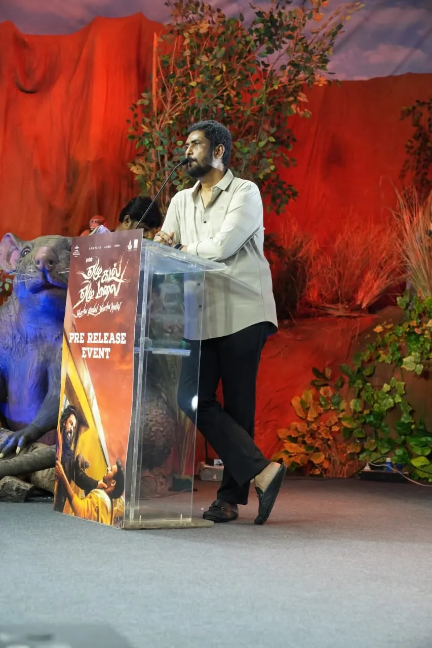 A speaker addresses the gathering from the film's decorated podium