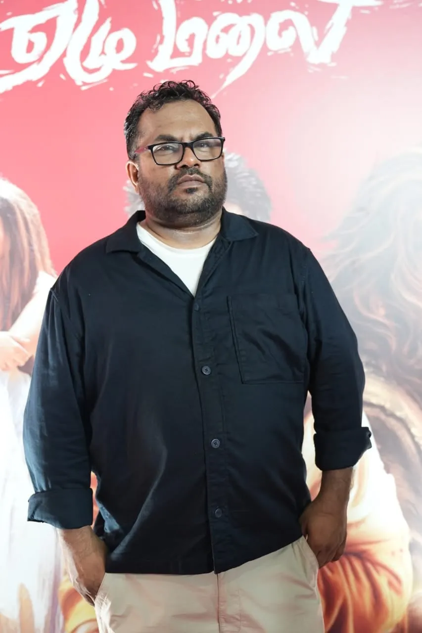 A guest poses before the film's illustrated backdrop