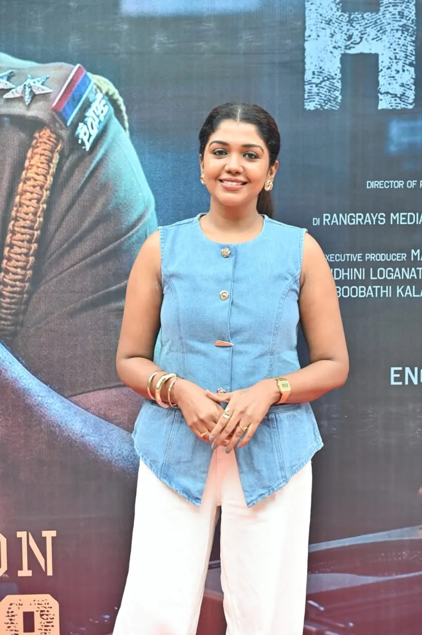 Portrait in a blue top against The Dark Heaven backdrop